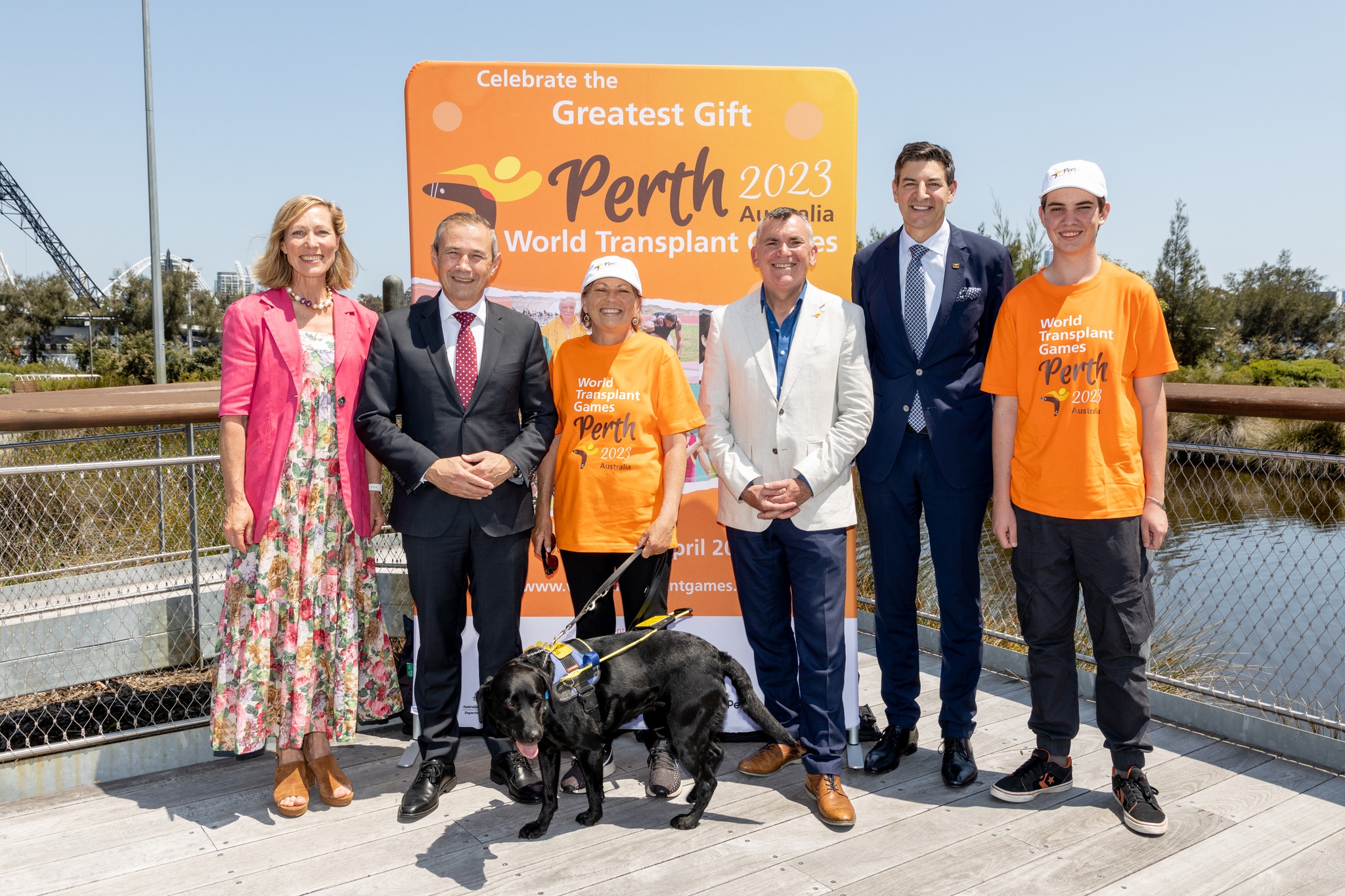 People standing in front of a sign for the World Transplant Games