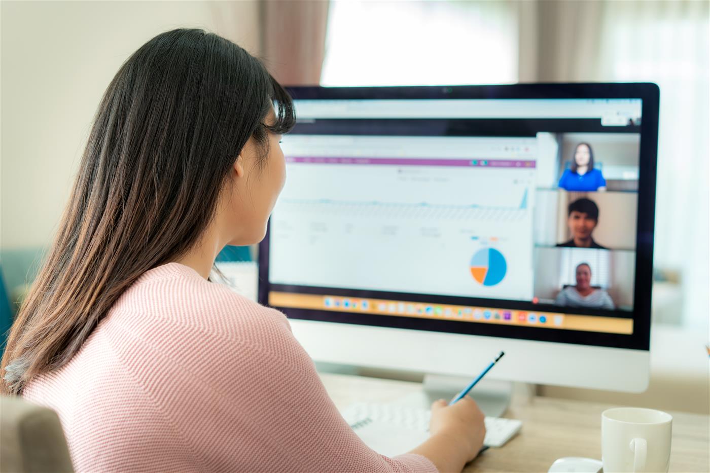A woman in front of her computer