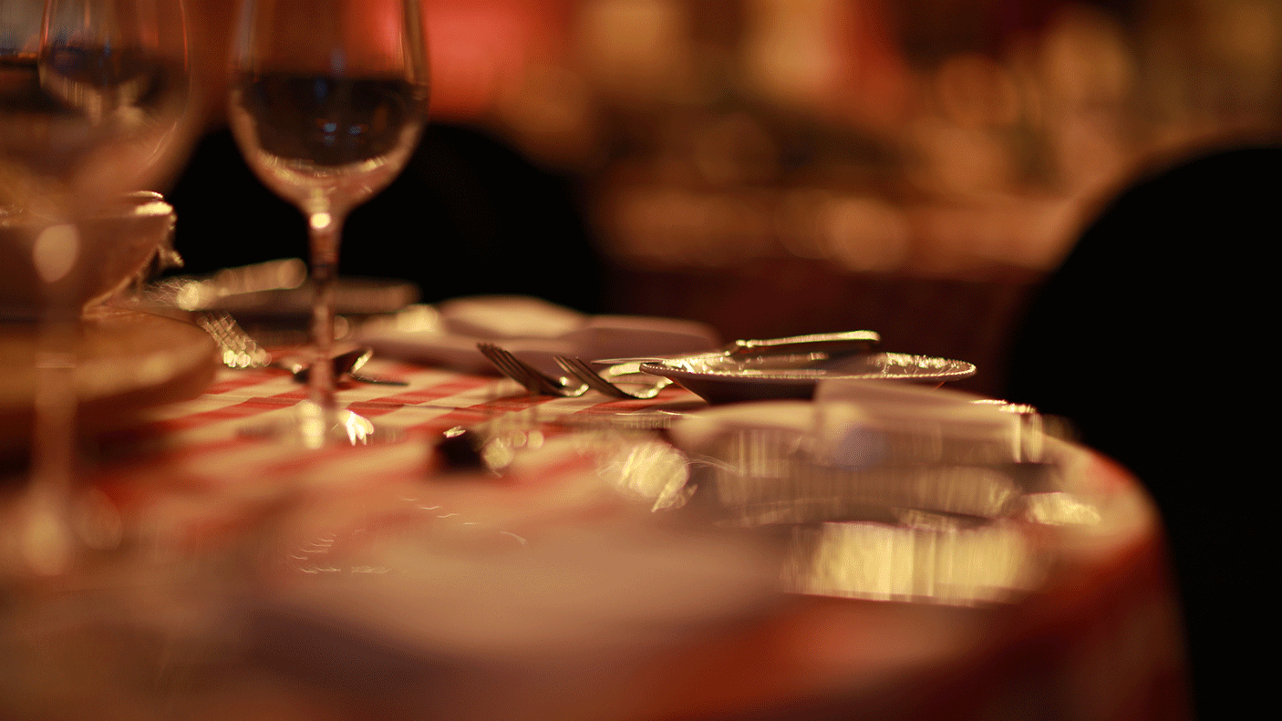 close up of a table set with plates and wine glasses