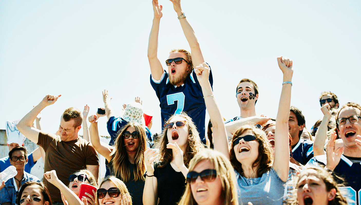 A group of people engaged in cheering on a sporting team